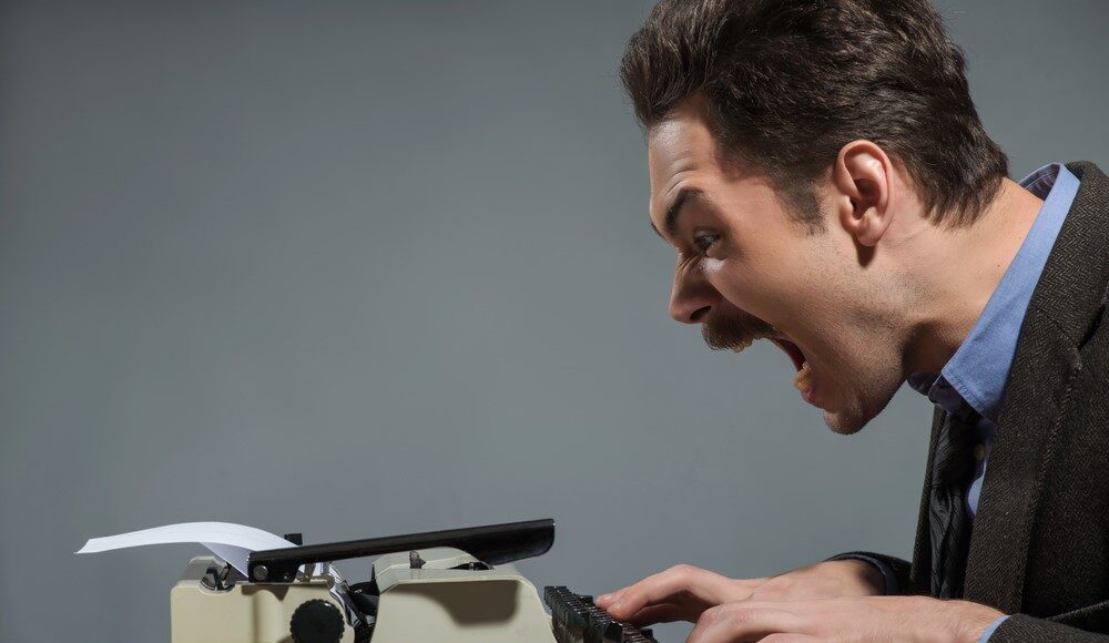 Coinbase-Trust-charter-ICBA-letter Legal clerk typing a letter on an old fashioned typewriter with ICBA logo, screaming as he drafts his letter to the OCC.