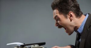 Inside ICBA’s Case Against Coinbase’s Trust Charter — and Why Coinbase Calls It Protectionism Legal clerk typing a letter on an old fashioned typewriter with ICBA logo, screaming as he drafts his letter to the OCC.