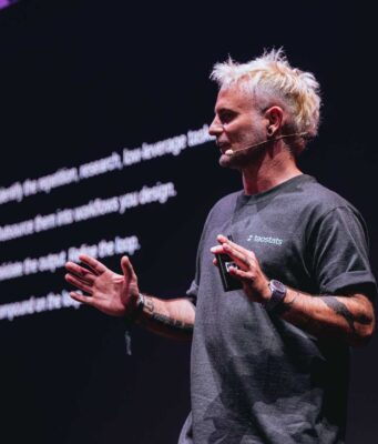 Exclusive Interview: Marcus “Mog” Graichen, The Translator of Bittensor Marcus Graichen, founder and CEO of Taostats, speaking on stage at the Proof of Talk 2026 summit in Paris.